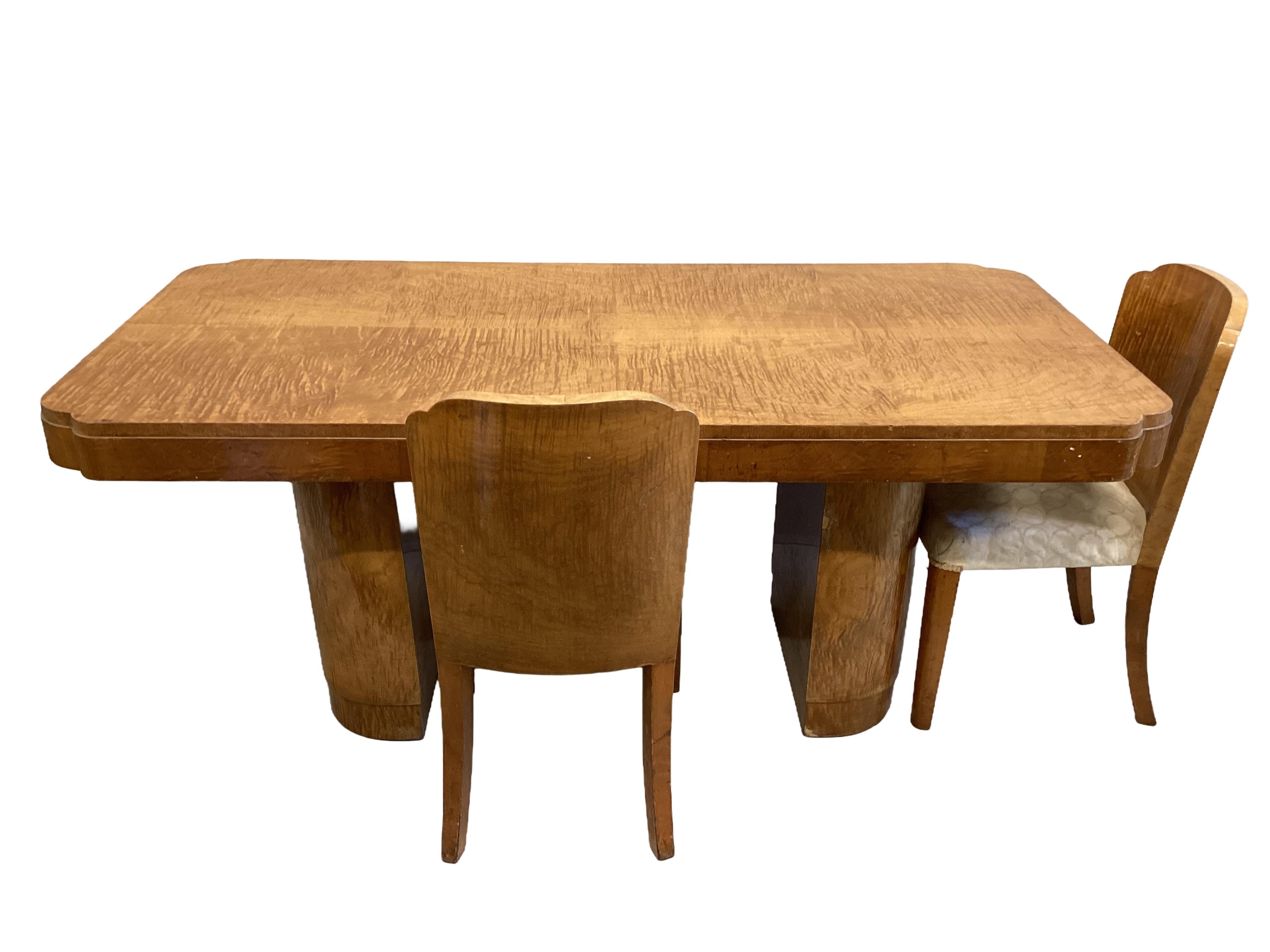 An Art Deco tiger maple dining table, width 184cm, depth 92cm, height 78cm and four chairs